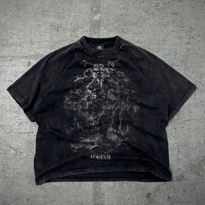 Black t-shirt with graphic design on a textured gray surface